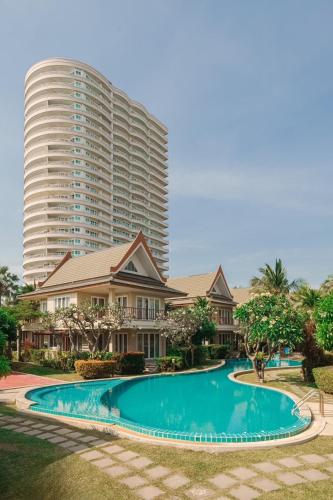 a large apartment building with a large swimming pool at Samran Beach House by May, Cha-am Beach in Cha Am