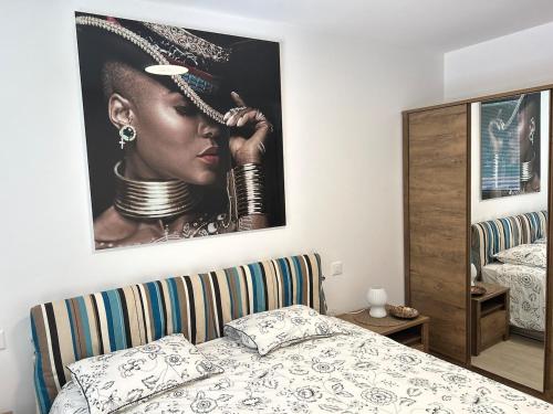 a bedroom with a picture of a woman on the wall at LabPark modern Melano in Melano