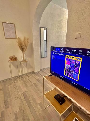 a living room with a flat screen tv on a table at Apartment Rea Ilidža 2 in Sarajevo