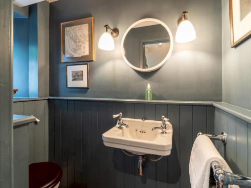 a bathroom with a sink and a mirror at The Old Reading Room Peaceful Village Retreat Pass the Keys in Wigginton