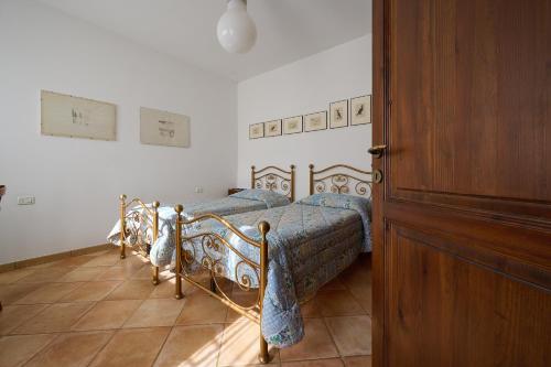 a bedroom with a bed with blue comforter at Poggio Diavolino - Suvereto in Suvereto