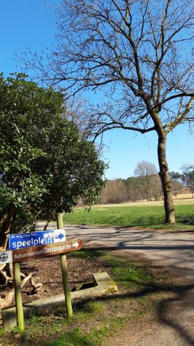 a street sign in a park with a tree at Villa in Diest nabij het groen in Diest