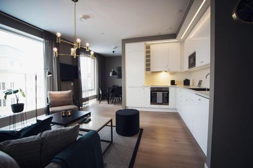 a kitchen and living room with a couch and a table at Sky Hotel City Apartments in Linköping