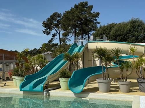 - un toboggan aquatique dans un complexe avec piscine dans l'établissement Bungalow Lodge 2 chambres, à Lège-Cap-Ferret