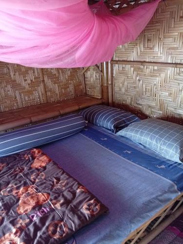 a room with two beds in a tent at Blue Moon Bungalow in Ko Bu Bu