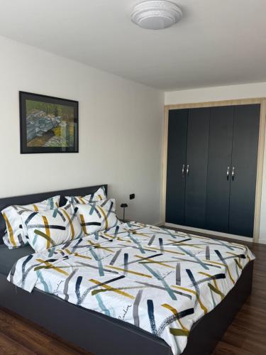 a bedroom with a bed with a colorful comforter at Nick Apartment in Pristina