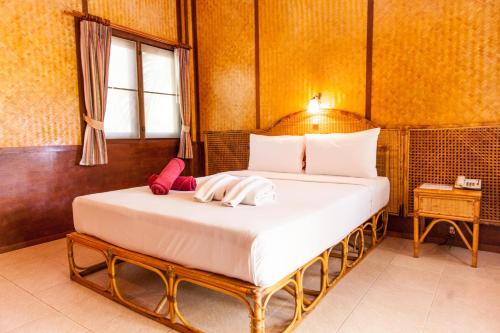 a bedroom with a bed in a room at Coco Palm Beach Resort - SHA Extra Plus in Mae Nam