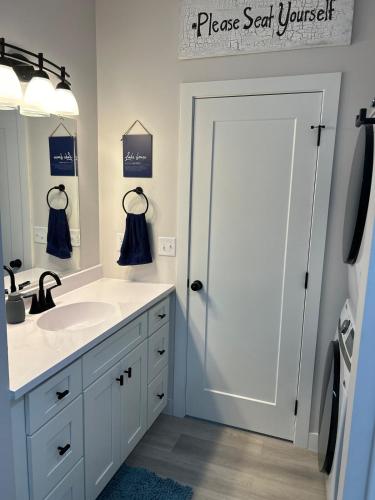 a bathroom with a sink and a large mirror at The Hygge House in Spirit Lake