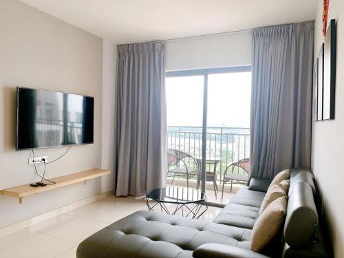 a living room with a couch and a large window at The Sun Avenue Serviced Apartment in Ho Chi Minh City