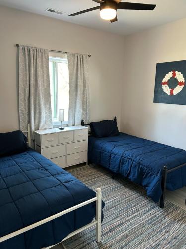 a bedroom with two beds and a window at The Hygge House in Spirit Lake