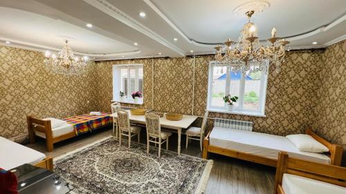 a living room with a dining table and a dining room at DADOW Guesthouse in Naryn