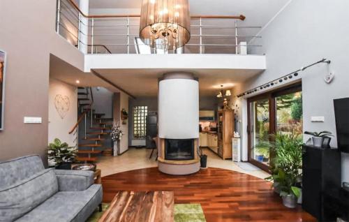 a living room with a couch and a fireplace at Five Bedroom Cozy Home In Jerzykowo 