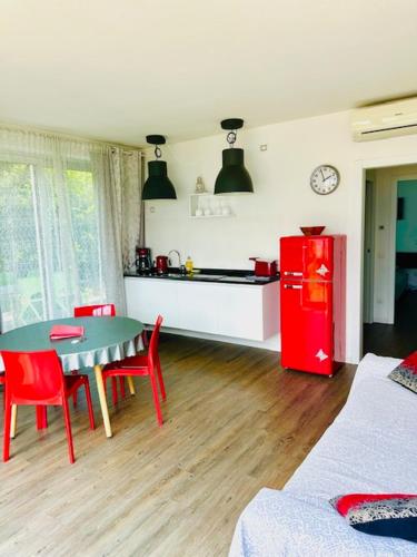 a kitchen with a table and a red refrigerator at Dock House in Marone