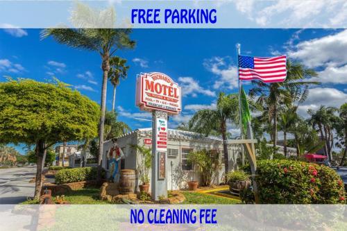 a sign for a motel with an american flag at Richard's Motel in Hollywood