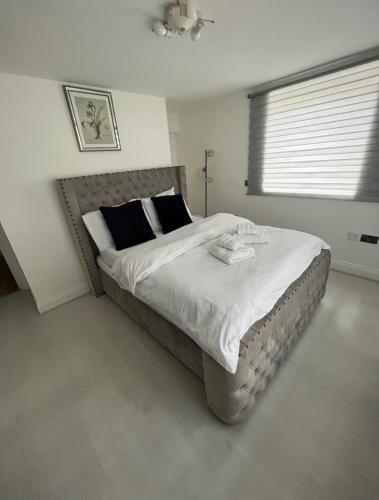 a bedroom with a large bed with white sheets at 2Bed Apartment-Free Parking Pets Garden Central in London