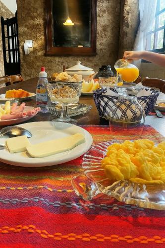 una tavola ricoperta di piatti di cibo e succo d'arancia di Pousada Arte Colonial - Casarão Histórico do Séc XVIII - Lancha Própria a Parati