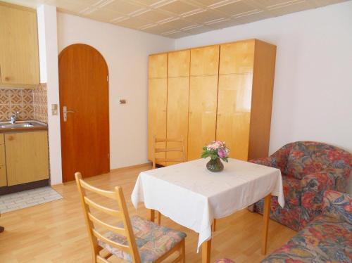 a living room with a table and a couch at Appartementhaus Fischer in Lindau