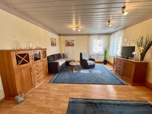 a living room with a couch and a tv at Ferienunterkünfte Familie Berger in Dessau