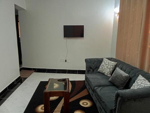 a living room with a couch and a tv at Leilani Homes in Kajiado