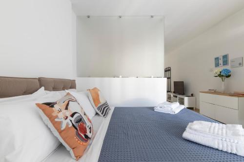 a bedroom with a bed with pillows on it at Little Rose in Catania