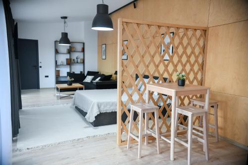 a bedroom with a bed and two stools in a room at Villa Alveare in Banya