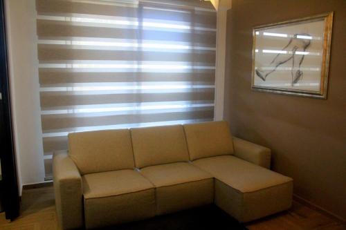 a living room with a couch and a window at Exclusive Hub 53 in Crotone