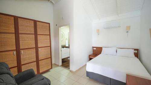 a bedroom with a bed and a chair in it at Pineloft Selimiye in Mugla