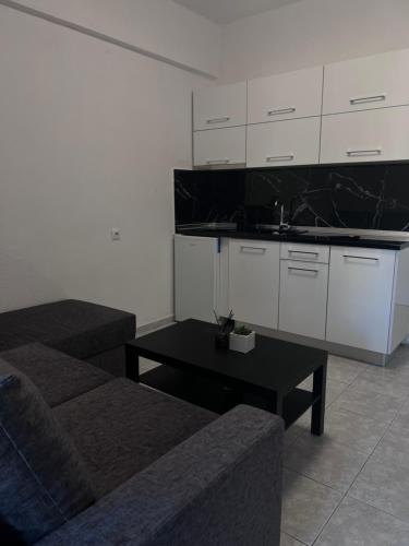 a living room with a couch and a table at Uka apartment in Nea Iraklia