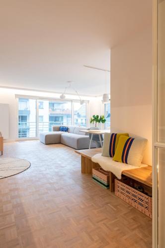 a living room with couches and a table at -Stay- at Oostduinkerke in Oostduinkerke