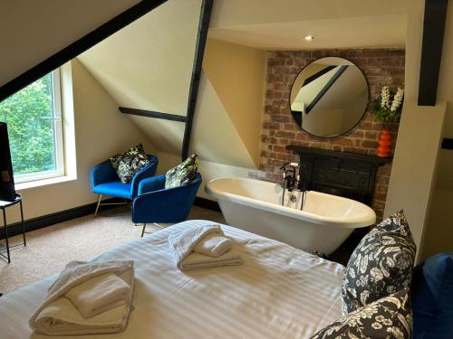 a bedroom with a bed and a sink and a mirror at The Goodrington Sands- Apart Hotel in Paignton