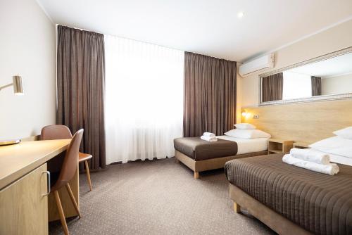 Postel nebo postele na pokoji v ubytování Hotel Boss