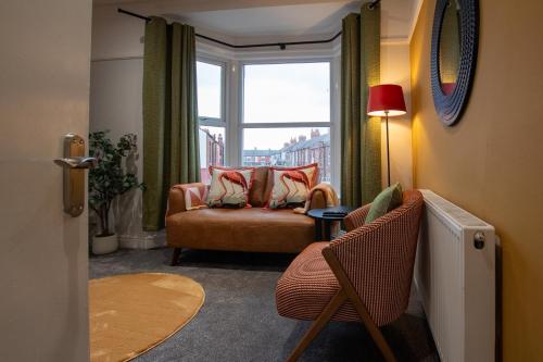 a living room with a chair and a window at Britannia Apartments in Liscard Village Wallasey by Rework Accommodation in Wallasey