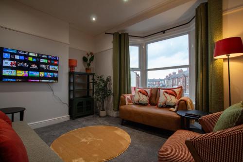 a living room with a couch and a large window at Britannia Apartments in Liscard Village Wallasey by Rework Accommodation in Wallasey