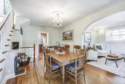 a dining room and living room with a table and chairs at Matisse B&B in Niagara on the Lake