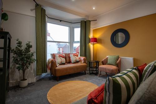 a living room with a couch and a chair and a window at Britannia Apartments in Liscard Village Wallasey by Rework Accommodation in Wallasey