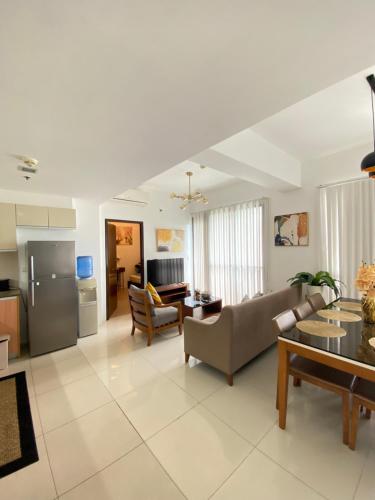 a living room with a couch and a table at One Manchester Place Mactan Newtown in Lapu Lapu City