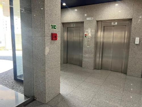 a hallway with two elevators in a building at Crystal Palace Oporto Flat - With Two Bedrooms in Porto