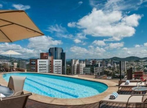 a large swimming pool on top of a building at Hotel & Residência Alphaville Flat in Barueri