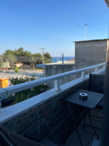a small table on the balcony of a building at Uka apartment in Nea Iraklia
