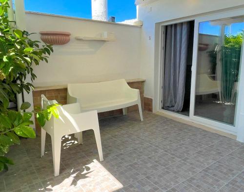 a white table and chairs on a patio at LA PERLA BIANCA Apartment - Near Train Station and Best Beaches with Amazing Sunsets in Anzio