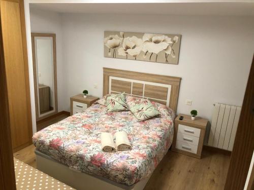 a bedroom with a bed with two slippers on it at El apartamento de la catedral in Burgos
