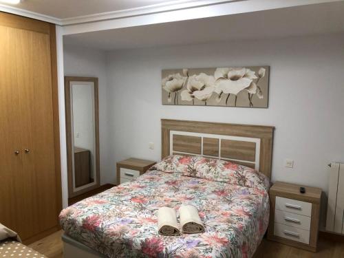 a bedroom with a bed with two slippers on it at El apartamento de la catedral in Burgos