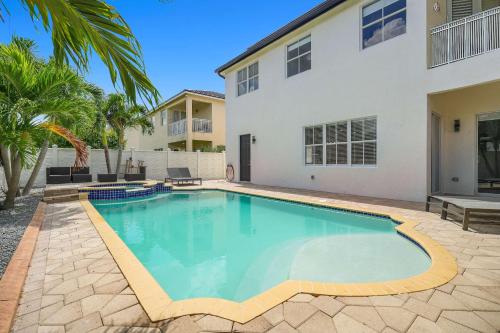 a swimming pool in front of a house at 5BD, 5BA, Tropical Oasis, Pool, Patio and Fun in Hialeah