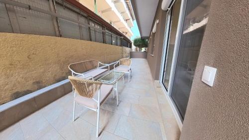 a row of chairs and a table in a building at The Elegant Areti in Olympiaki Akti