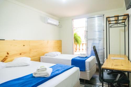 Ένα ή περισσότερα κρεβάτια σε δωμάτιο στο Hotel Estancia Santa Amélia