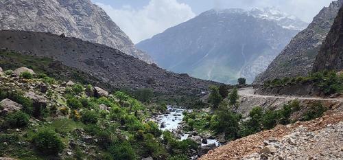a mountain valley with a road and a river at Guldara Guest House 