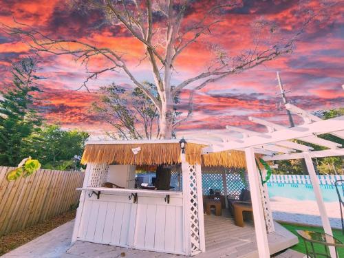 a white shed with a painting of a tree at 5 Bed Heated Pool Largo, Seminole FL 2 mi Indian Rocks Beach , Pets, Game room in Seminole
