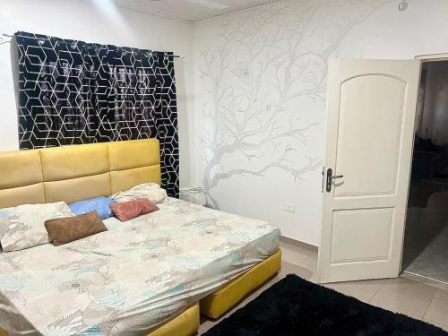 a bedroom with a bed and a wall at Lighthouse in Trofwi