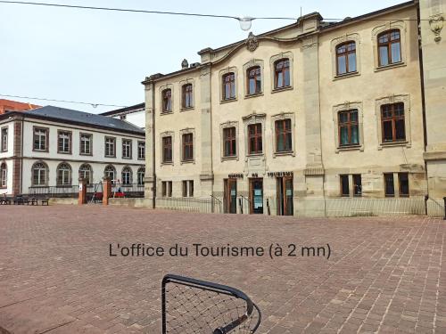 a bench sitting in front of a building at Chambre - Centre historique - Equipée - Salle d'eau et WC privés in Colmar