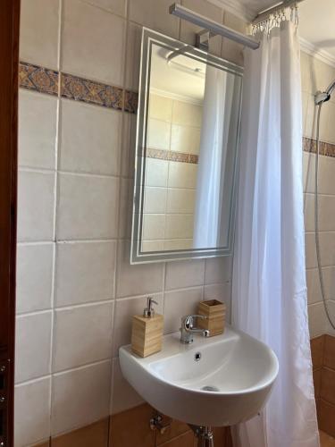 a bathroom with a sink and a mirror at Anatèlia Beach House in Portianón
